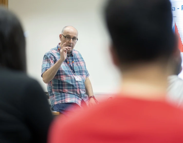 A lecturer engages with students in a classroom at Glasgow Kelvin College, with population graphs on screen. A lecturer engages with students in a classroom at Glasgow Kelvin College, with population graphs on screen.